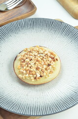 Serabi pancake with peanut topping and condensed milk, a traditional Indonesian snack