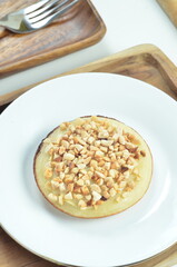 Serabi pancake with peanut topping and condensed milk, a traditional Indonesian snack