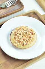 Serabi pancake with peanut topping and condensed milk, a traditional Indonesian snack
