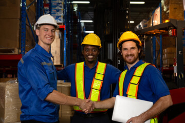 Group of diverse industrial factory workers shaking hands with deals and warehouse for deal with logistics.