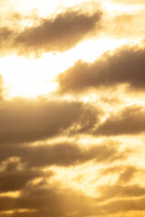A breathtaking and stunning view of golden clouds beautifully illuminated by the warm glow of the setting sun