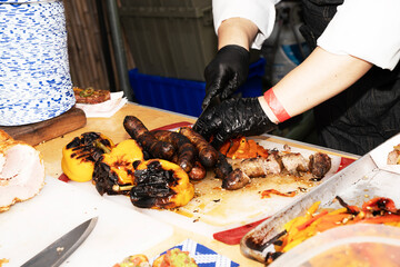 chef prepares sausage outdoors