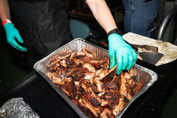 CHef prepares ribs outdoors