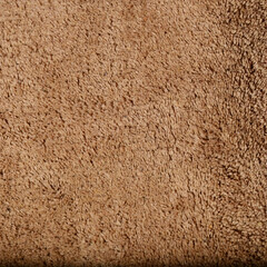 A clean and cozy bathmat placed neatly on a modern bathroom floor. The mat features a soft, textured surface designed to absorb water and provide comfort underfoot.