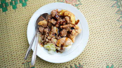 Siomay Bandung or Shumay or steamed dumplings with boiled tofu. Indonesian traditional street food with peanut sauce.
