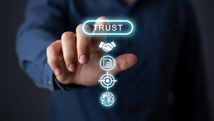 Person touching glowing trust button with handshake document target and gear icons finger