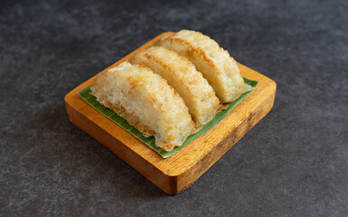 Kue Pancong, Gandos or Bandros is Indonesian traditional snack. This cake is a traditional food from the Betawi people. It is made from a mixture of rice flour, grated coconut, sugar, and coconut milk