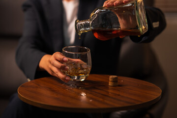 Pour the whiskey into the glass