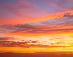 Obraz premium Vivid sunset hues paint the sky with streaks of orange, pink, and purple clouds