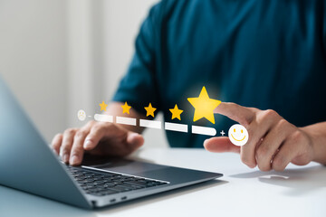 user feedback and five-star rating system. Man using laptop and selecting maximum star level with smiley icon, representing excellent digital experience and customer satisfaction.