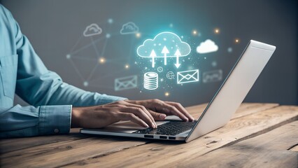 Person using laptop with digital cloud and data icons floating above on a wooden desk surface