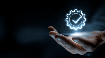 Quality assurance concept with glowing gear and check mark icon floating above open hand in dark background