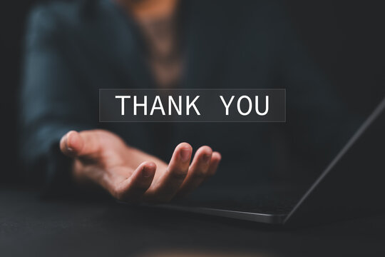 Businessman using a laptop and holding the message thank you on a display screen. Concept of thank you business, congratulations, and appreciation gratitude. Presentation from technology digital