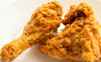 crispy fried chicken on white plate close up