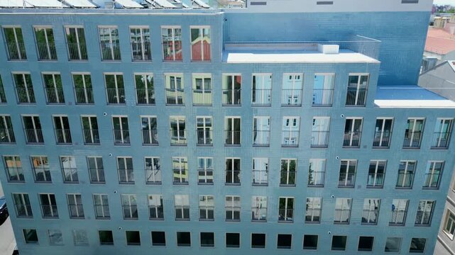 Aerial descending view from a modern building with solar panels at rooftop and mirrored windows.
Lisbon,Portugal.