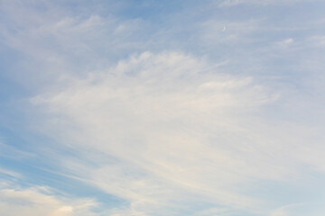 Soft Clouds and a Crescent Moon in the Late Afternoon Sky