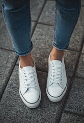 Close-up of casual outfit details with white sneakers