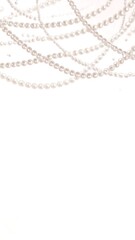 Delicate pearl strands against a soft, muted background