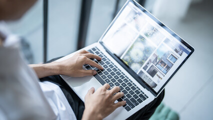 The man is focused on his laptop screen typing work or a task at hand..