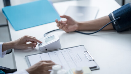 Medical Examination Doctor Conducting Blood Pressure Test on Patient for Diagnosisใ
