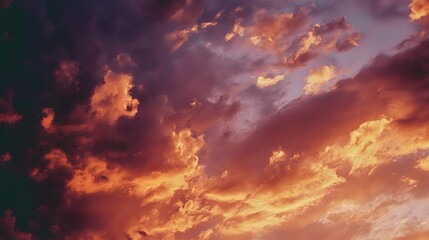 Fototapeta premium Dramatic clouds ablaze with sunset hues.