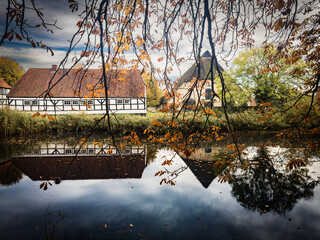 Gut Wulfshagen reflecting in a pond in Schleswig-Holstein, Germany.