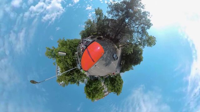 Little planet format of driving along a streets in Munich , Germany Bavaria on a sunny day in summer.