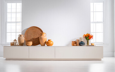 Modern home decor display with pottery, vases, and floral arrangements in a bright interior setting