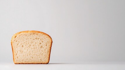 Single slice of white bread on a light gray background