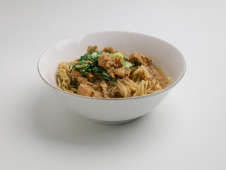Chicken noodles and meatballs soup in white bowl 