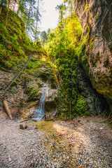 Waterfall with ladder in canyon, sucha bela in Slovak Paradise or Slovensky Raj National Park in Slovakia.