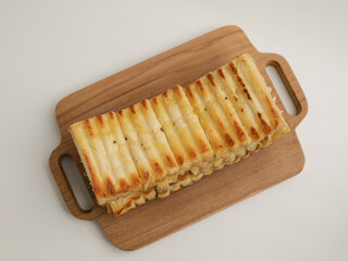 Toasted bread on wooden tray