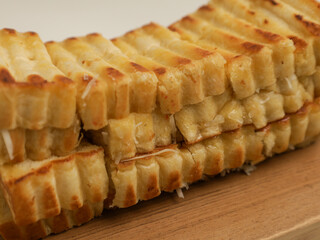 Toasted bread on wooden tray