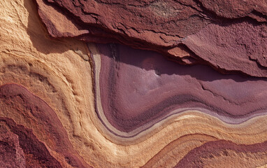 A detailed photograph of the wavy rock formations in Al Ula, Saudi Arabia.