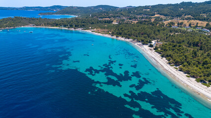 Drone aerial view of Port Glarokavos and Lagoon Beach in the Kassandra Peninsula, Halkidiki region, Greece