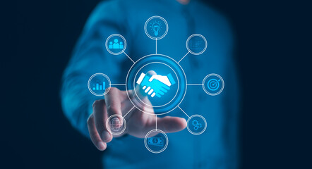 Global Business Partnership and Collaboration. A businessman touching a handshake icon at the center of a digital network, strategic alliances, financial growth, innovation, business ecosystem.