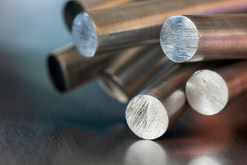 Bundle of aluminum rods in industrial setting, close-up view of metal structure