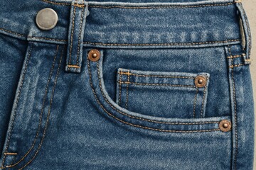 Close up of classic blue denim jeans pocket and button detail