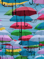 Decorative umbrellas over a street in a popular tourist spot