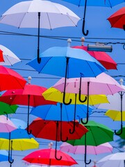 Decorative umbrellas over a street in a popular tourist spot