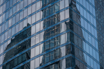 walls and empty windows of a modern building on a big city street without people