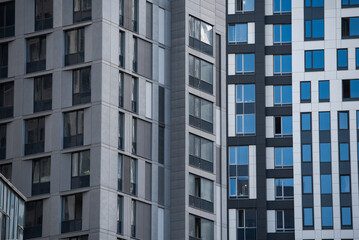empty glass windows of a modern building with a reflection of the sky in the glass