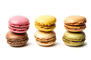 Small colorful tasty sweet original classic macaroons cakes isolated on white studio background