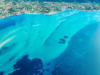 Seacoast with shades of turquoise water with beaches and blue lagoons in Karidi in Sithonia Peninsula, Vourvourou bay, Halkidiki, North Greece © Zedspider
