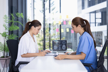 Female doctor and nurse working together, Two doctor woman working with x ray in modern clinic.
