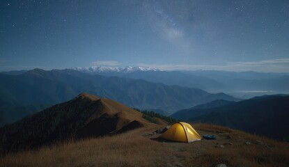 Yellow tent atop mountain at night. Stars, Milky Way, and distant peaks