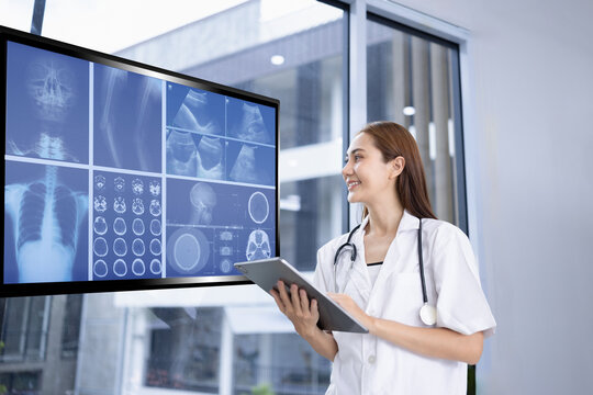 female doctor interacting with a holographic medical interface, concept of  physician pointing at a digital anatomy display.