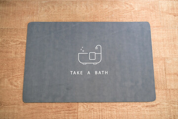 Stylish mat on the floor in the bathroom, Interior design.