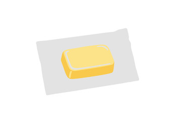 A yellow bar of butter sits on a shiny light grey wrapper