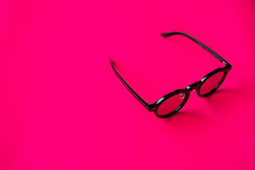 Black Glasses on Vibrant Pink Background